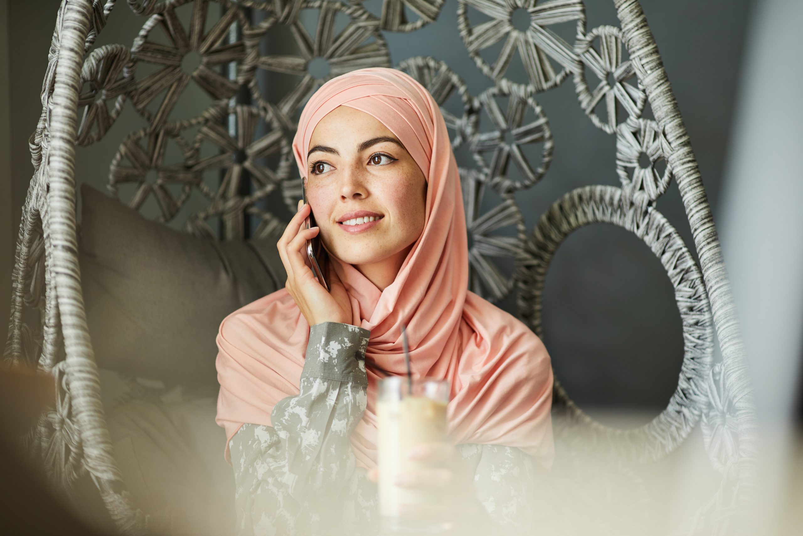 Pretty Muslim woman talking on phone